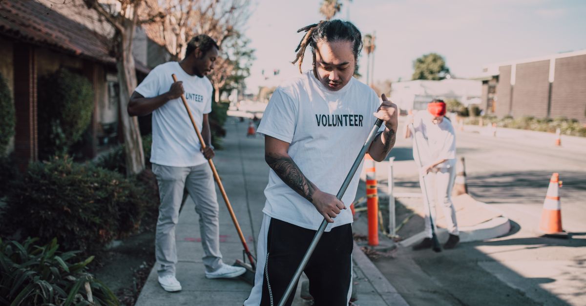Community volunteers cleaning up streets to promote environmental awareness and social good.